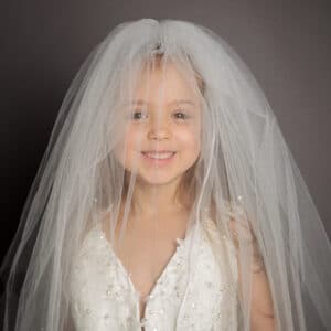 Mummy’s Wedding Dress Portrait Photo Shoot West Sussex a little girl wearing her mum's wedding veil