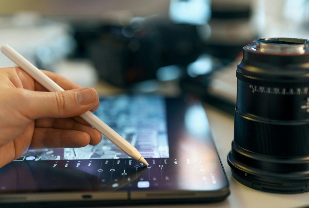 a photographer editing an image on a tablet