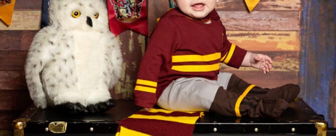 a little boy in a Harry Potter Quidditch outfit with Harry Potter themed props
