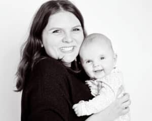 Family Portrait Photo Shoot East Grinstead West Sussex a mum poses with her daughter in a black and white professional portrait studio image against a white background