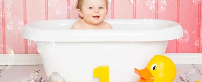 a little girl in a bathtub in a cloud of bubbles