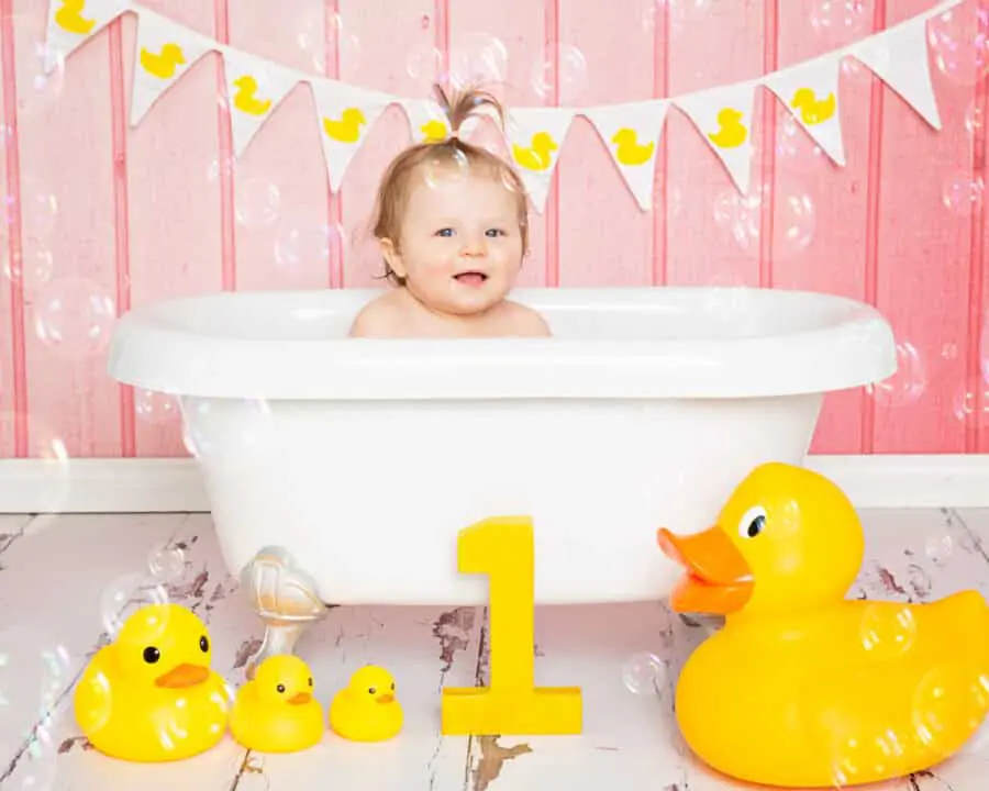 a little girl in a bathtub in a cloud of bubbles