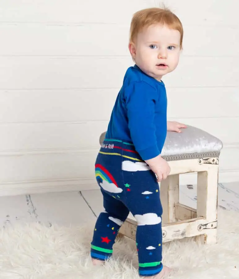 Baby Photography East Grinstead West Sussex a little boy in rainbow themed leggings and a blue top