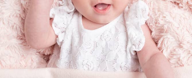 a little girl with a pink personalised blanket