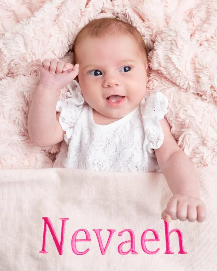 Baby Photography East Grinstead West Sussex a little girl with a pink personalised blanket
