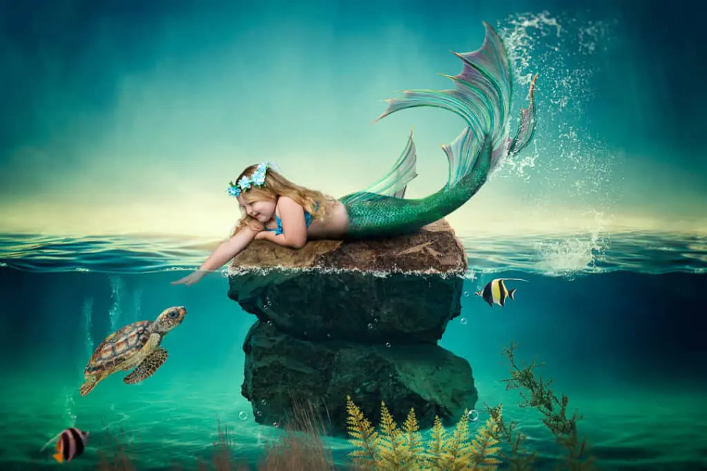 a little girl reaches down to pet a turtle in a digital mermaid artwork
