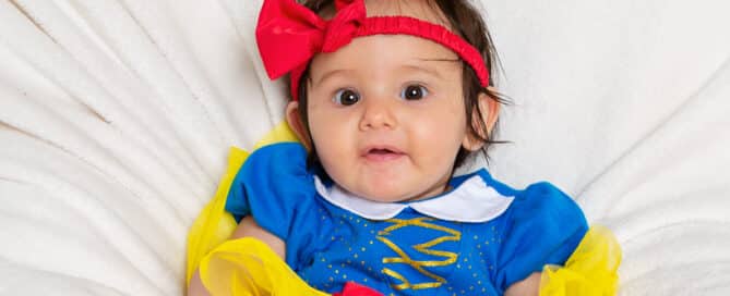 a little girl in a snow white princess outfit