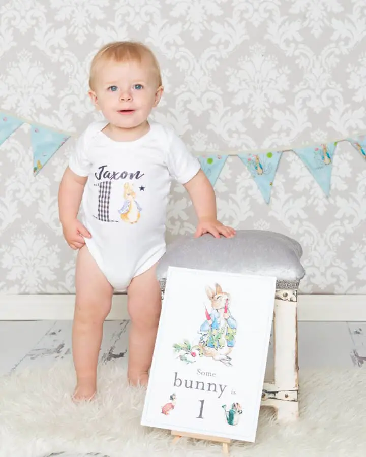 a little boy standing next to a footstool with some Peter Rabbit Props
