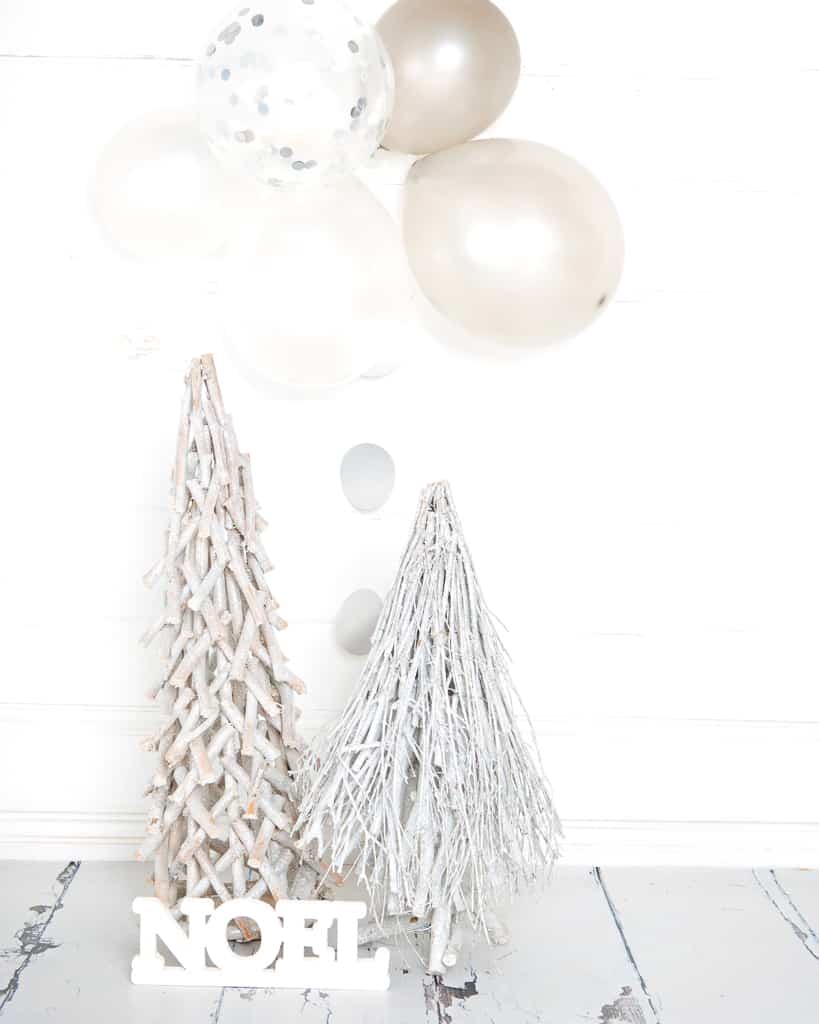 a white and silver festive tree themed set at a Christmas mini photo shoot