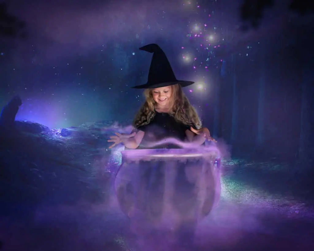 a digital image of a little girl leaning over a cauldron in a Halloween themed photo