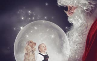 a snowglobe digital image with a baby and a dog looking up at Santa