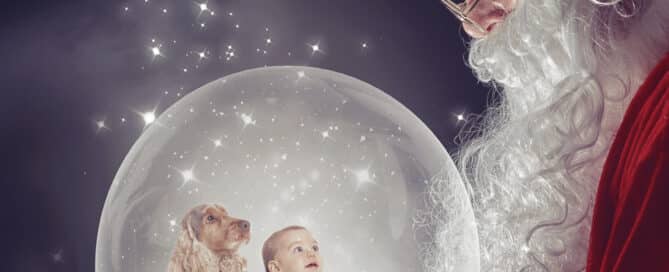 a snowglobe digital image with a baby and a dog looking up at Santa