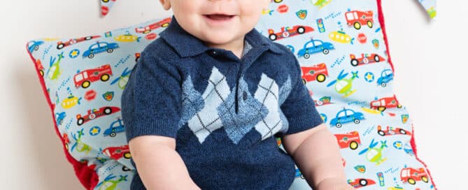 a little boy is holding a wooden truck and posing for his photo at a professional photo shoot