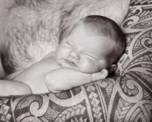 Newborn Photography East Grinstead West Sussex a little baby sleeps in dad's tattooed arm