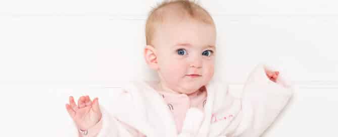a little girl in a pink dressing gown at a professional photoshoot