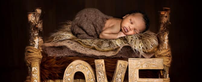 a little boy sleeps on a fur covered bed in a digital newborn composite image