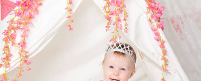 a little girl in a flower decorated teepee