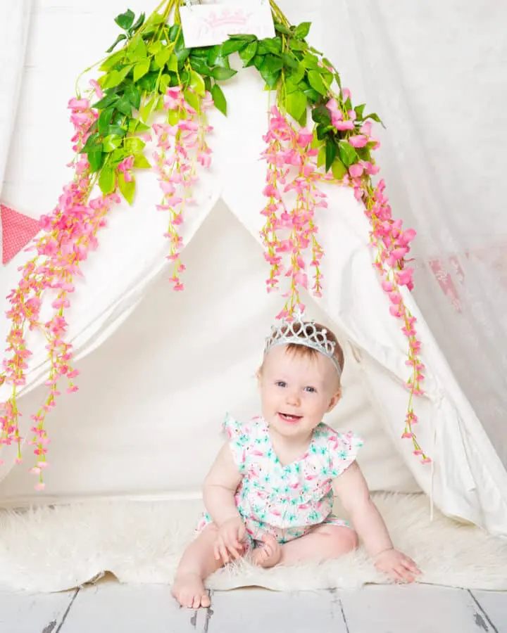 Baby Photography East Grinstead West Sussex a little girl in a flower decorated teepee