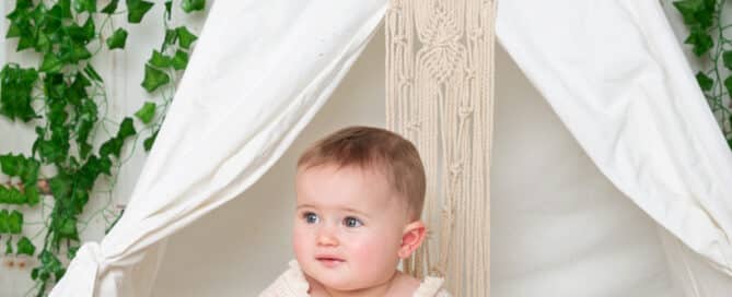 a little girl in a Boho Style outfit in a teepee with sunflowers
