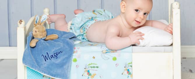 a little boy on a Peter Rabbit themed bed
