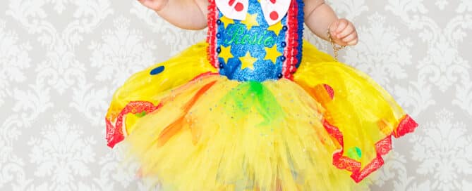 a little girl in a large Mr Tumble themed dress