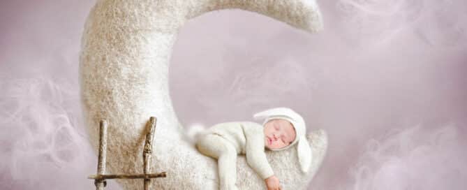 a sleeping newborn on the moon in a digitally created image
