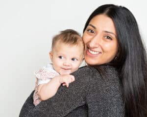 a mum and daughter pose for the camera smilng