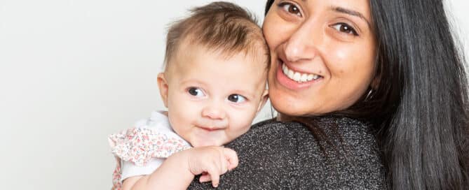a mum and daughter pose for the camera smilng