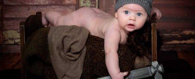 a little boy on a bed in a viking costume