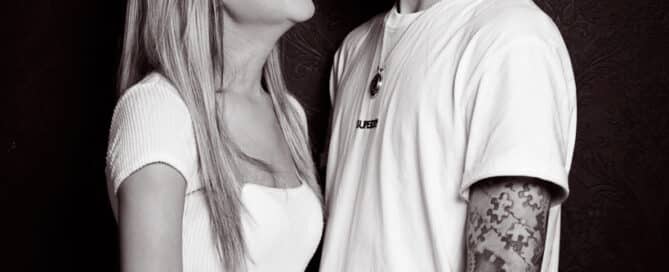 a black and white image of a happy couple looking at each other in the portrait studio