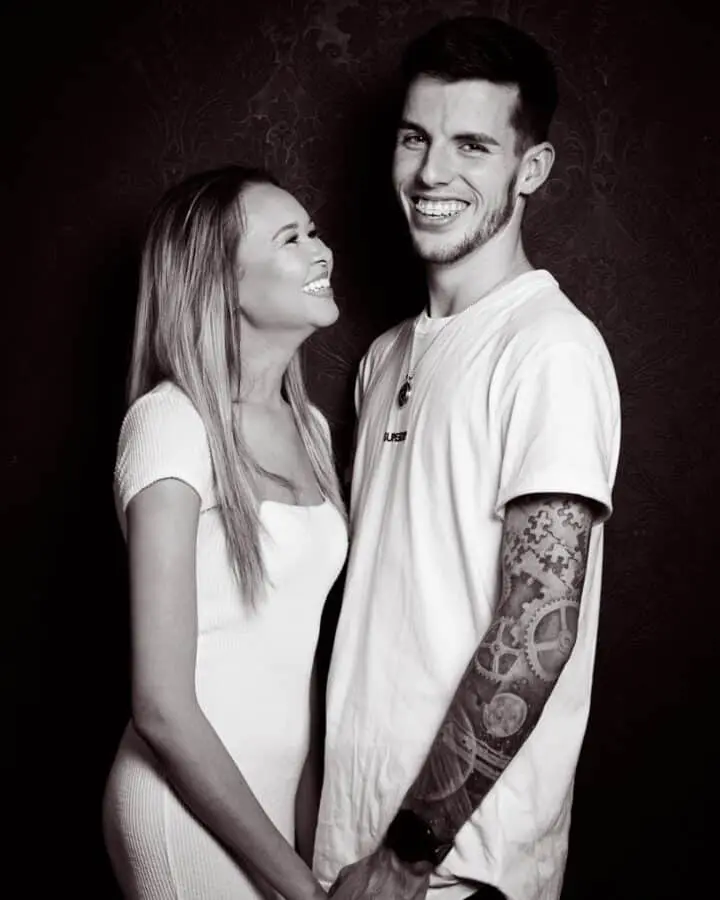 a black and white image of a happy couple looking at each other in the portrait studio