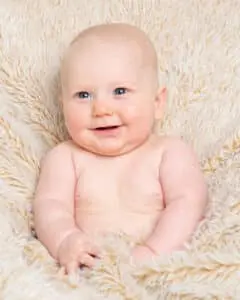 a baby tucked up in a fluffy blanket