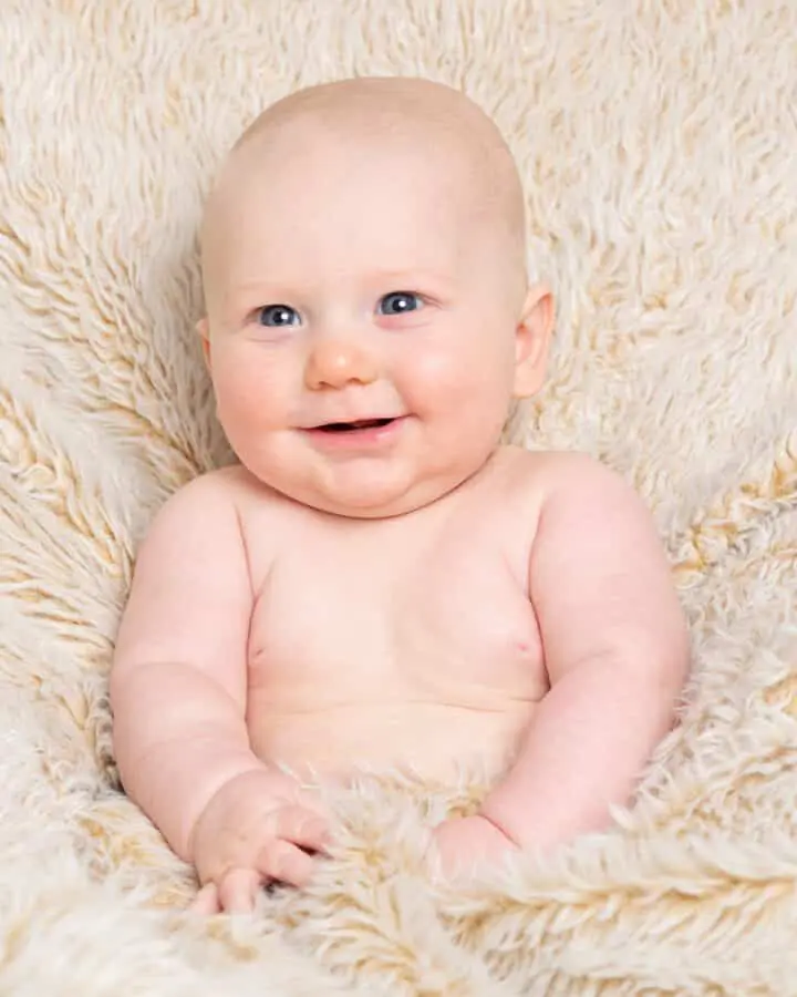 Baby Photography East Grinstead West Sussex a baby tucked up in a fluffy blanket