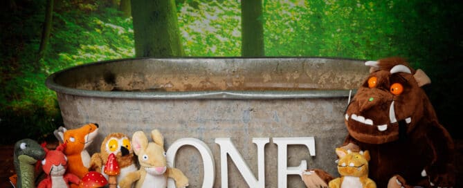 A tin tub in a woodland setting featuring the Gruffalo stuffed toy characters