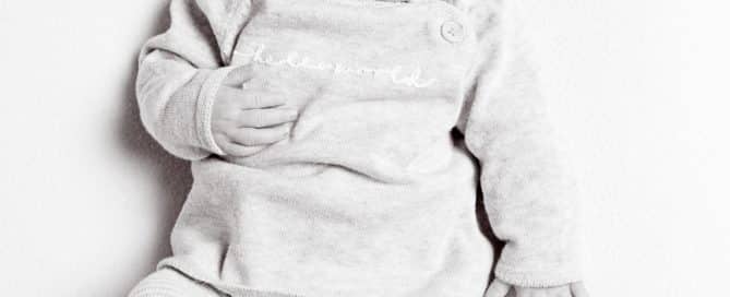 a black and white image of a sleeping newborn viewed from the top