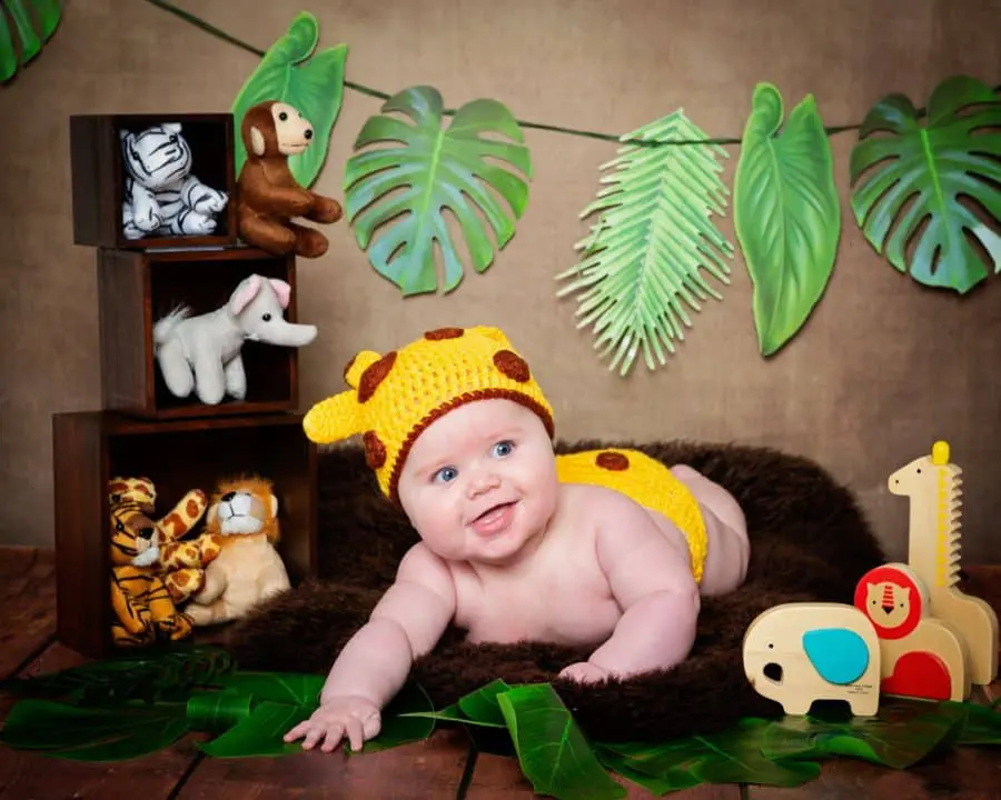 Baby Photography East Grinstead West Sussex a little boy in a giraffe costume with jungle props