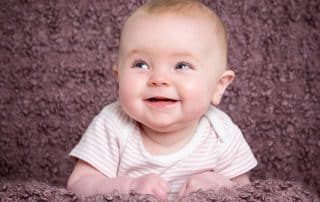 a little girl on a light purple background