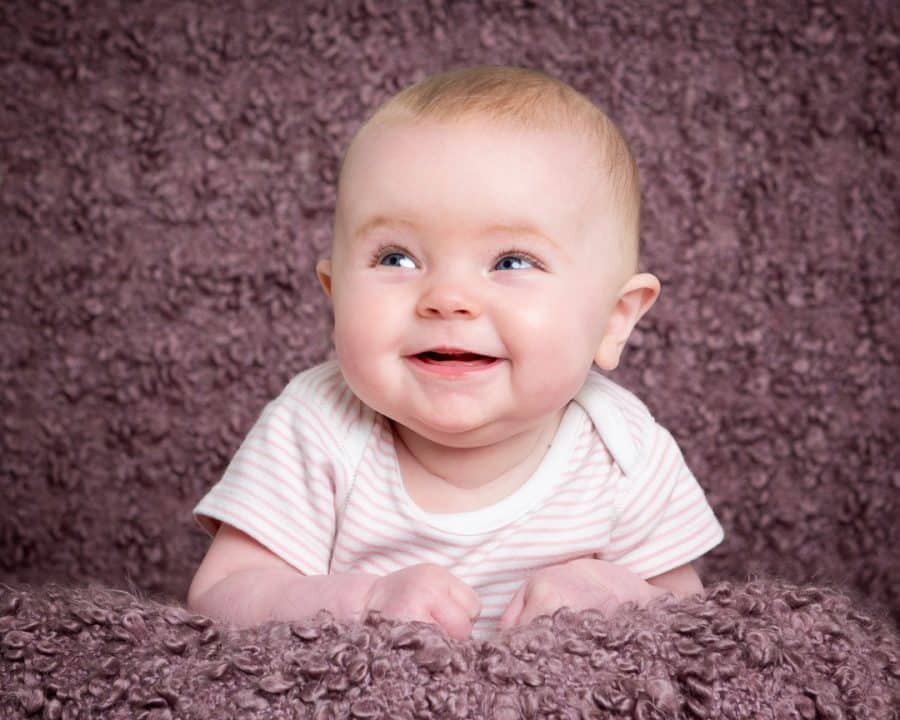 a little girl on a light purple background