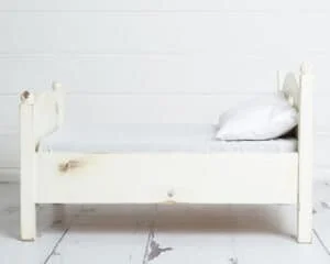 white miniature wooden bed prop