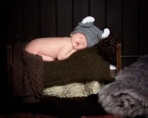 a newborn dressed as a viking at a professional photo shoot