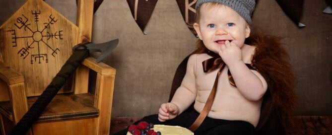 a little boy dressed as a viking at a themed cake smash photo shoot
