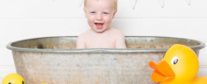 a duck themed tub splash photo shoot with a white backdrop