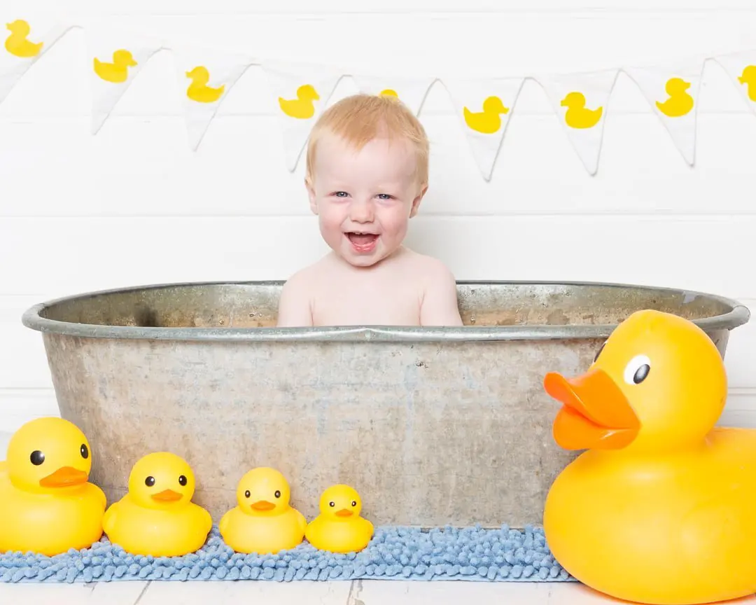 a duck themed tub splash photo shoot with a white backdrop