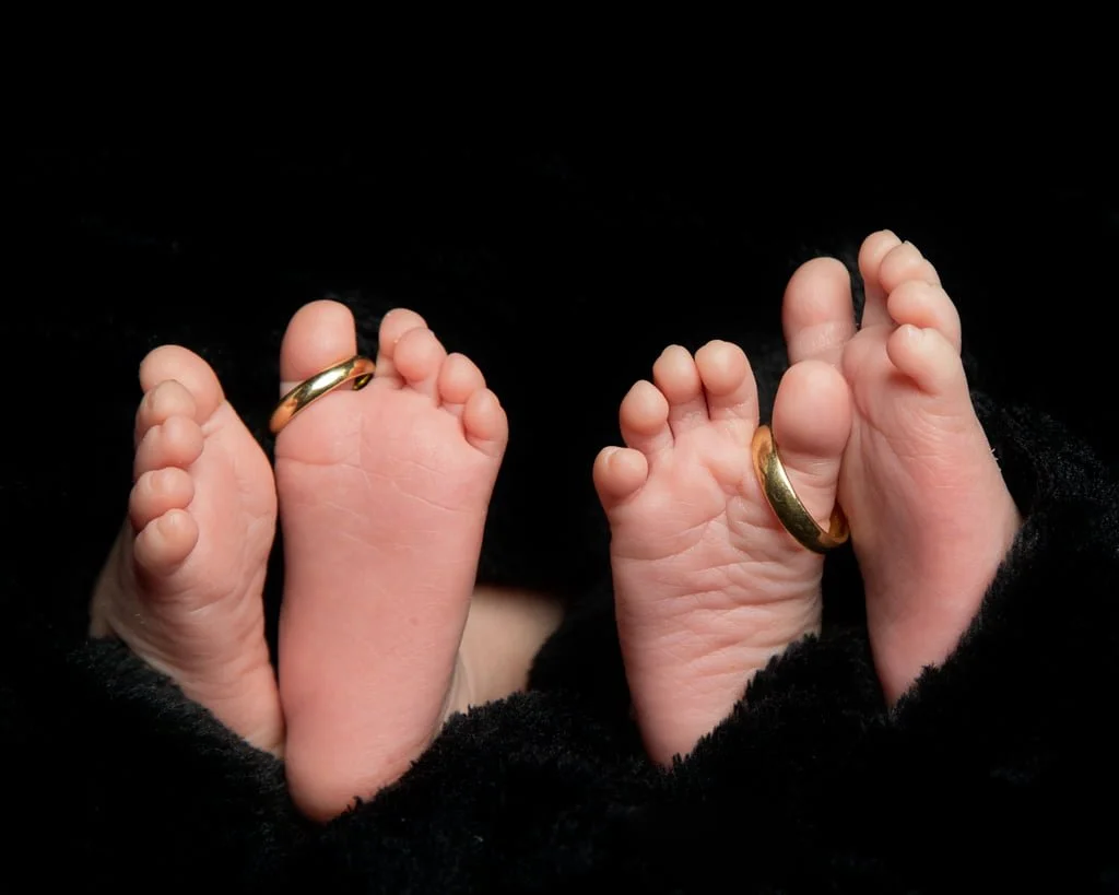 Newborn Twin Photography in the Studio East Grinstead two sets of newborn feet at a twin photo shoot