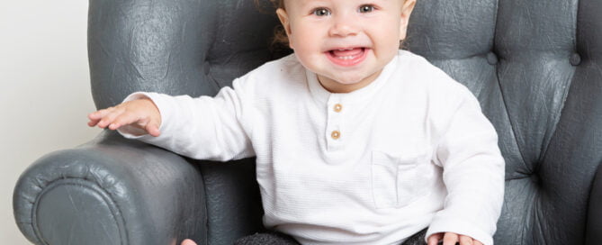 a little boy with fluffy hair poses for a photo