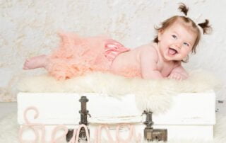 a little girl with bunches on my vintage suitcase