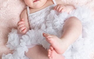 a little girl in a fluffy white pettidress