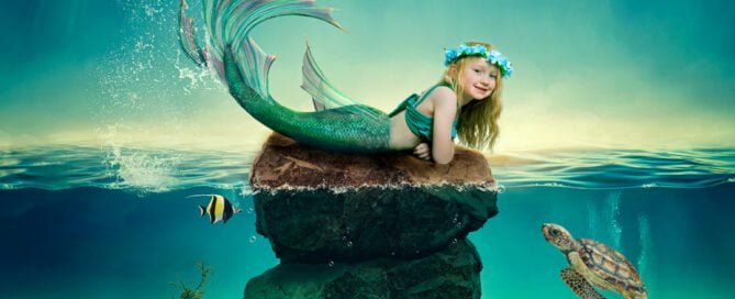 a little girl in a floral headdress at a mermaid photo shoot