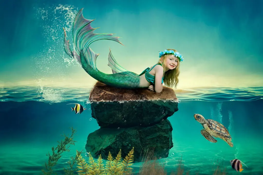 a little girl in a floral headdress at a mermaid photo shoot