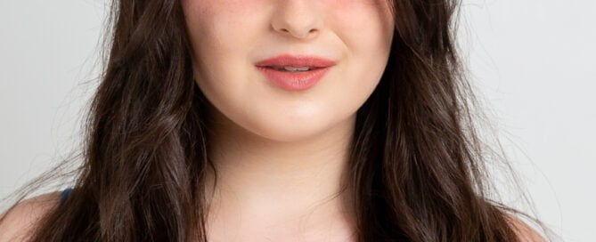 A teen girl poses for a headshot up